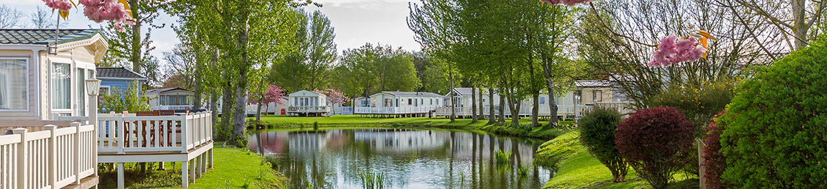 Lovely spring photo of holiday caravans by a lake
