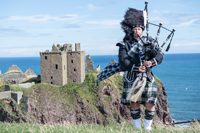 Scotish man playing bagpipes